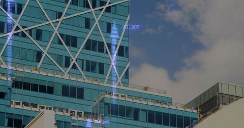 Teal glass office tower featuring diagonal lattice facade and rooftop terraces