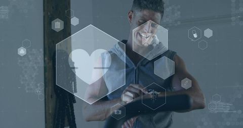 Fit man tracking fitness with wearable health technology in gym