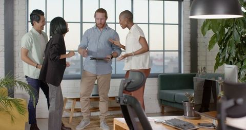 Diverse team celebrating a successful project in modern workplace