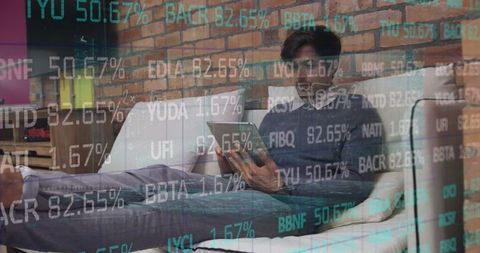 Young Professional Analyzing Financial Data on Tablet at Home