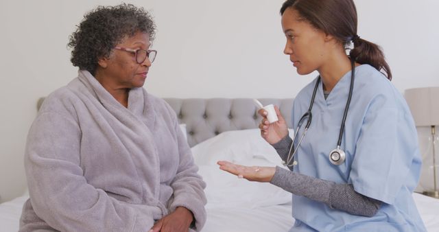 Nurse Discussing Medication with Elderly Patient at Home - Download Free Stock Images Pikwizard.com