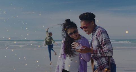Friends Sharing Moment at Beach with Energetic Dance in Background