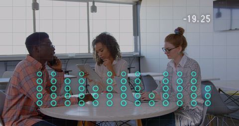 Diverse Team Analyzing Data with Digital Graph Overlay in Modern Office