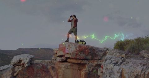 Hiker observing scenic panorama with vibrant neons