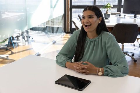 Businesswoman in Modern Office Discussing Ideas at Meeting Table