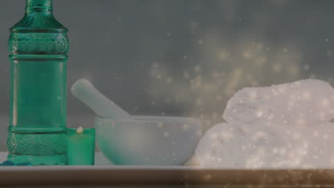 Relaxing Spa Scene with Towels, Bottle, and Candle