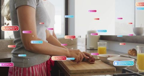 Woman Cooking Sausage with Social Icons Overlay in Modern Kitchen