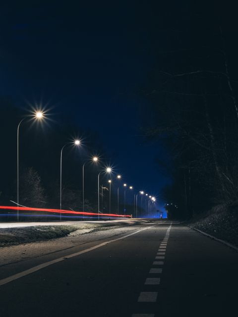 Night Road with Street Lights and Light Trails from Passing Cars - Download Free Stock Images Pikwizard.com