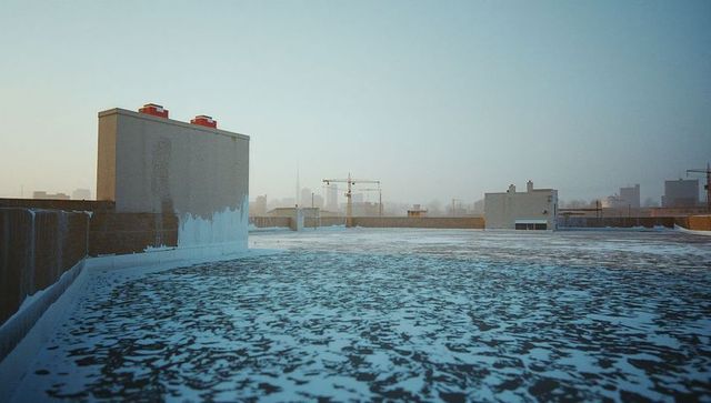 Frosty Urban Rooftop with Distant City Skyline at Dawn