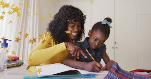 Mother Enthusiastically Guiding Daughter with Homework at Home