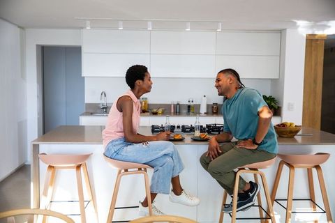 Diverse Couple Enjoying Casual Conversation in Modern Kitchen