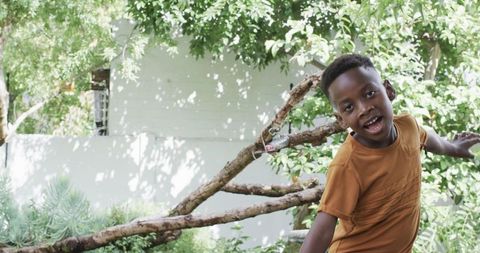 Joyful African American Boy Playing Outdoors in Nature