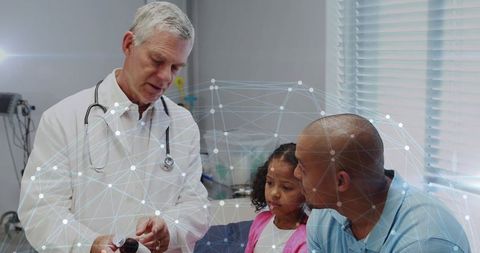 Doctor explaining medication to father and daughter in clinic