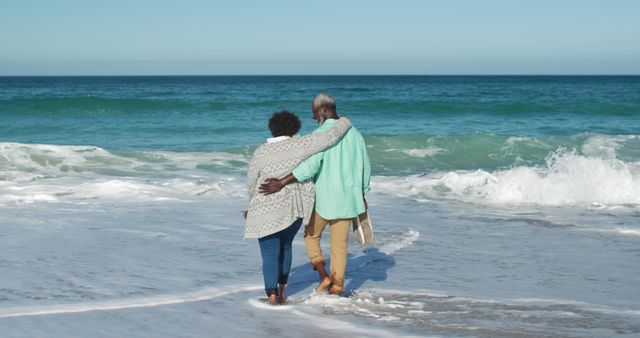 Senior Couple Walking on Beach Embracing - Download Free Stock Images Pikwizard.com