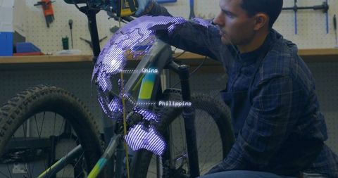 Fixing Electric Mountain Bike with Holographic Global Supply Chain Overlay, Mechanic Working