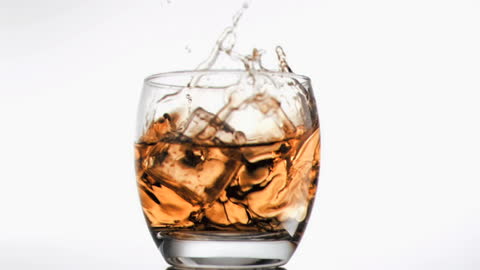 Whiskey with Splash and Ice Cubes Floating
