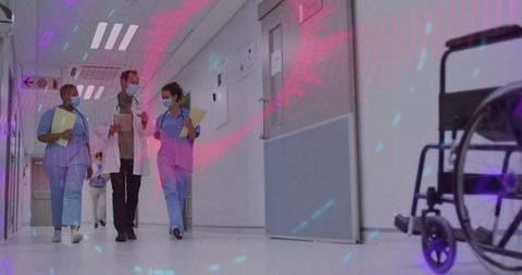 Medical professionals walking in hospital corridor with digital overlay