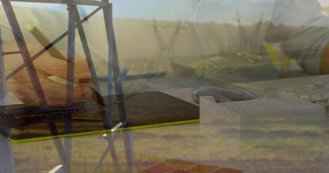 Layered notebook transmission tower double exposure blending desk workspace rural horizon