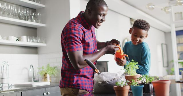 Father and son enjoying gardening together indoors. This image can be used to showcase family bonding, teaching children about nature, or promoting indoor gardening activities. It can also be used in content related to sustainable living, home projects, or family-oriented advertisements.