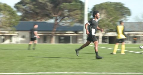 Teen soccer players competing intensely on field