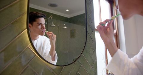 Young Biracial Man Practicing Oral Hygiene in Bathroom Mirror - Download Free Stock Images Pikwizard.com