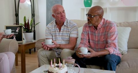 Senior Friends Celebrating with Cake and Coffee in Cozy Living Room