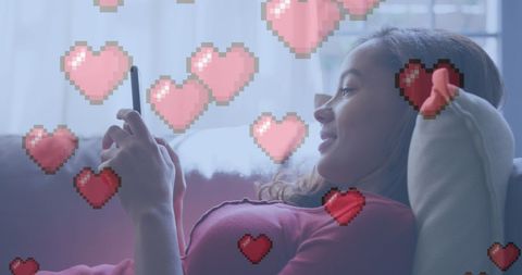 Woman Engaged with Smartphone Has Pixelated Heart Graphics at Home