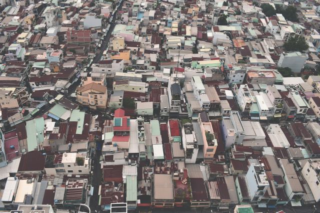 This image captures a densely packed urban residential area from an aerial perspective. Ideal for illustrating urban development, housing studies, city planning, crowded living conditions, and infrastructure projects, it provides a visual representation of densely populated areas in city environments. Can also be used in articles or discussions about urbanization and its impact on living spaces.
