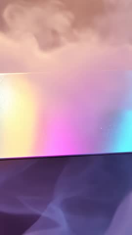 Vertical iridescent panel rotating and revealing prismatic light shifting across fabric and vapor