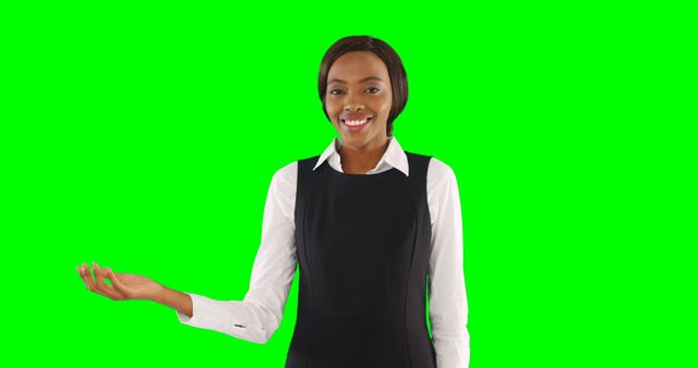 Smiling professional woman presenting on green screen background - Download Free Stock Images Pikwizard.com
