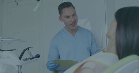 Dentist Explaining Dental Care to Patient in Treatment Room
