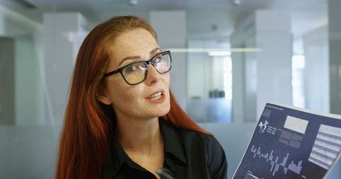 Professional Businesswoman Presenting Financial Chart in Modern Office