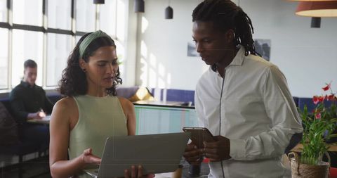 Diverse Business Team Collaborating on Project with Technology