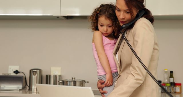 Multitasking Mother Working from Home while Holding Child - Download Free Stock Images Pikwizard.com