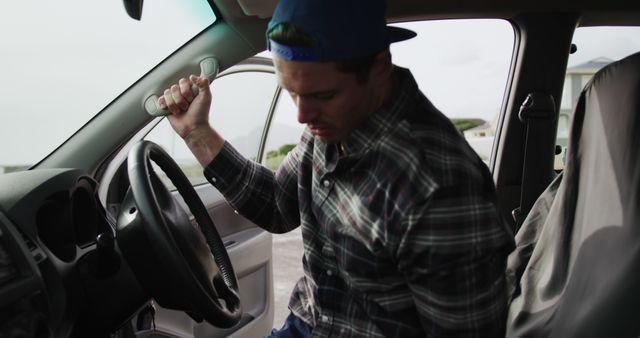 Young Man Getting Into Car with Determined Expression in Daylight - Download Free Stock Images Pikwizard.com