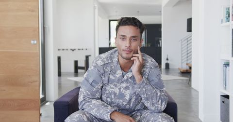 Contemplative Soldier in Camo Uniform Relaxing at Home