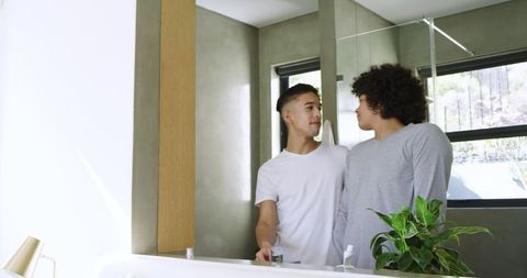 Couple Enjoying Intimate Moment at Vanity in Modern Bathroom