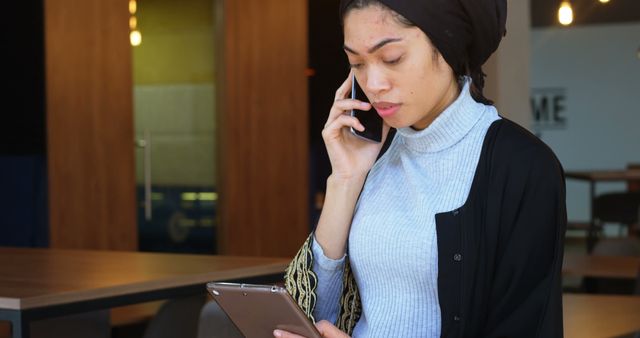 Businesswoman Multitasking with Phone and Tablet in Modern Office - Download Free Stock Images Pikwizard.com