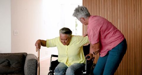 Senior Couple Supportively Transitioning from Wheelchair at Home