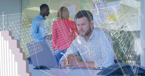 Bearded Professional Typing on Laptop with AR Data Visuals in Vibrant Office