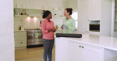 Diverse Female Friends Bonding Pre-Workout in Modern Kitchen
