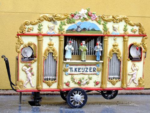 Vintage mechanical organ on wheels with figurines