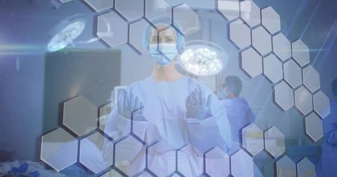 Scrubbed surgeon preparing for operation in or with hexagonal tech overlay