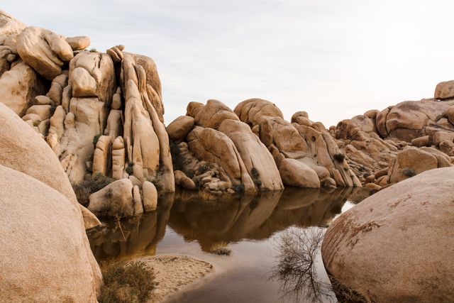Scenic Reflection of Rocky Formations in Calm Desert Water - Download Free Stock Photos Pikwizard.com