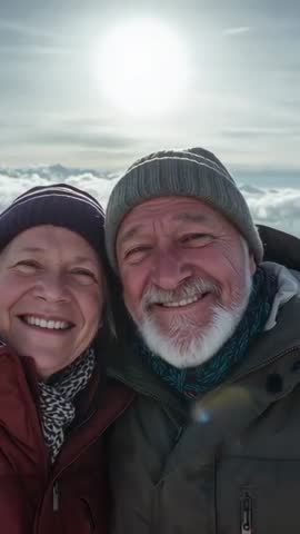Senior Couple Smiling on Alpine Ridge Above Clouds Backlit Vertical Travel Video