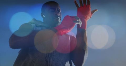 Athletic Boxer Wrapping Hands with Red Handwraps for Training