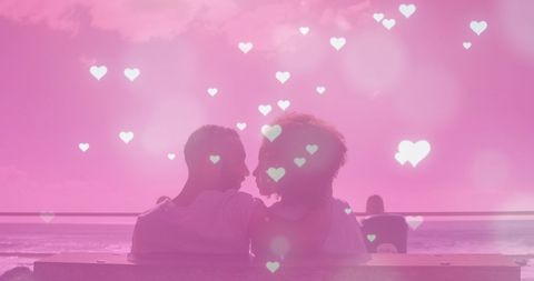 Romantic Couple Kissing at Sunset Beach with Heart Overlay