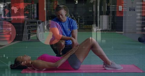 Woman Performing Core Exercise with Coach in Modern Gym