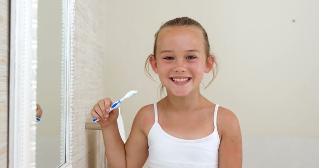 Smiling Young Girl Holding Toothbrush in Morning Routine - Download Free Stock Images Pikwizard.com