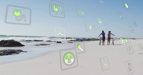Couple strolling on beach with eco-friendly energy icons floating